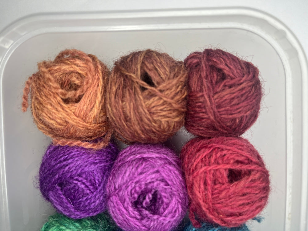 12 little balls of Shetland hand dyed 4 ply yarn