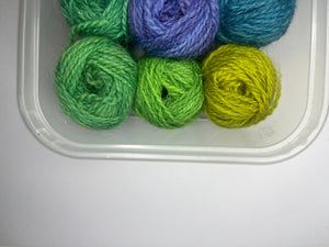 12 little balls of Shetland hand dyed 4 ply yarn