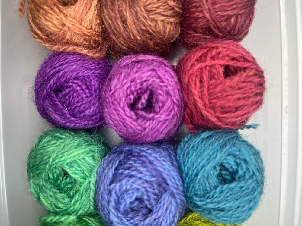 12 little balls of Shetland hand dyed 4 ply yarn