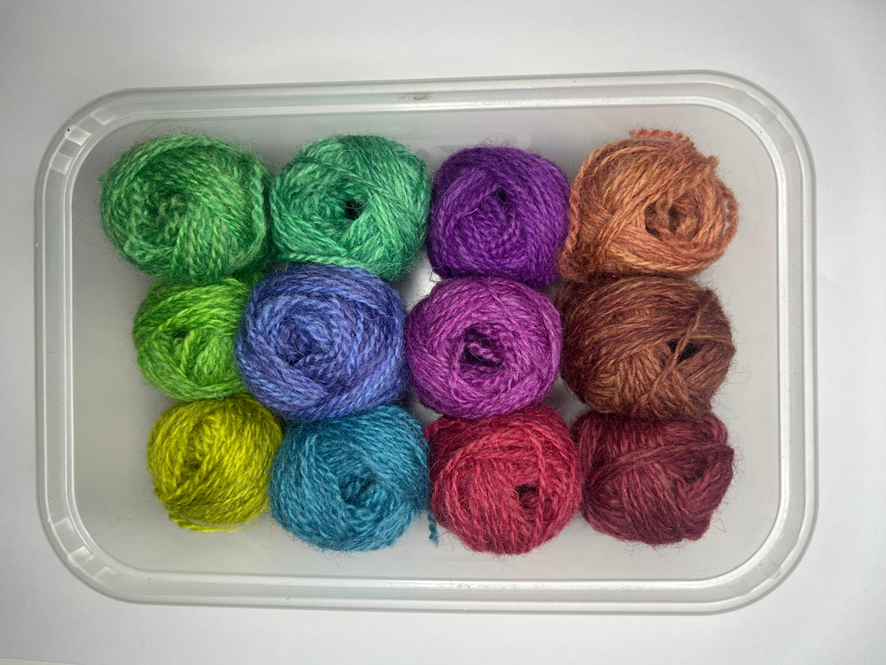 12 little balls of Shetland hand dyed 4 ply yarn